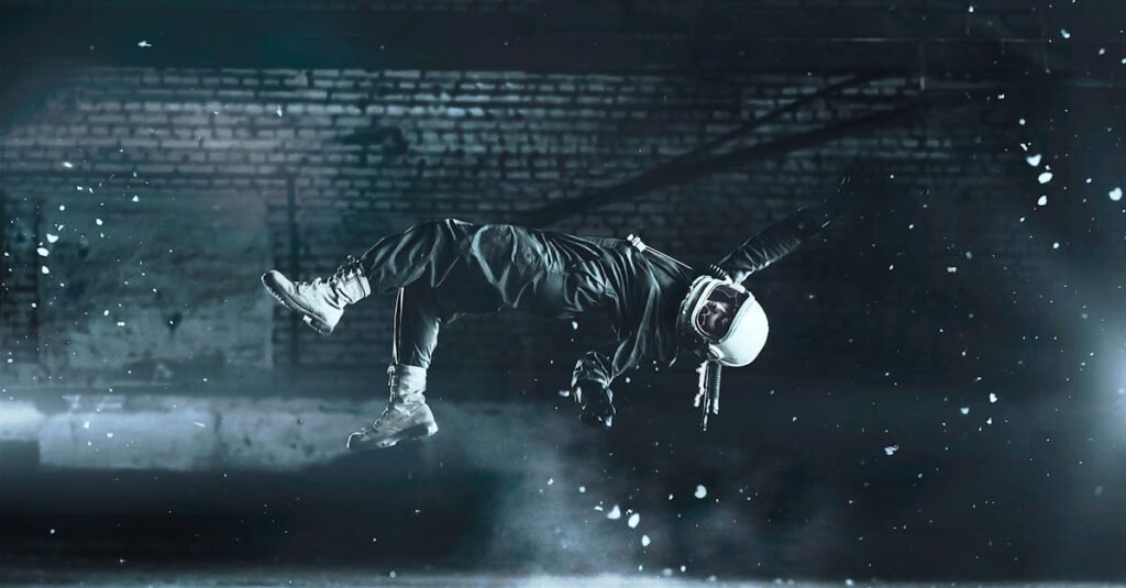 A cosmonaut floats effortlessly in an artistic fashion amidst a dimly lit indoor space.