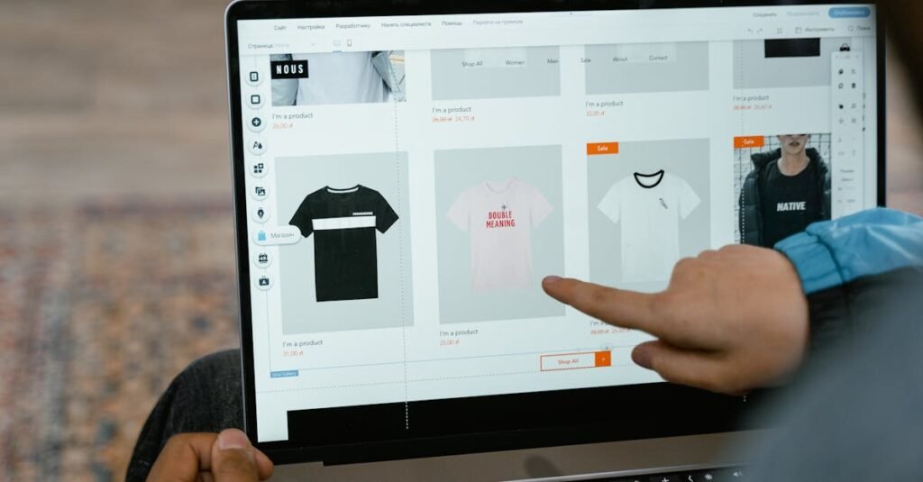 A person points to t-shirt options in an online store on a laptop screen.