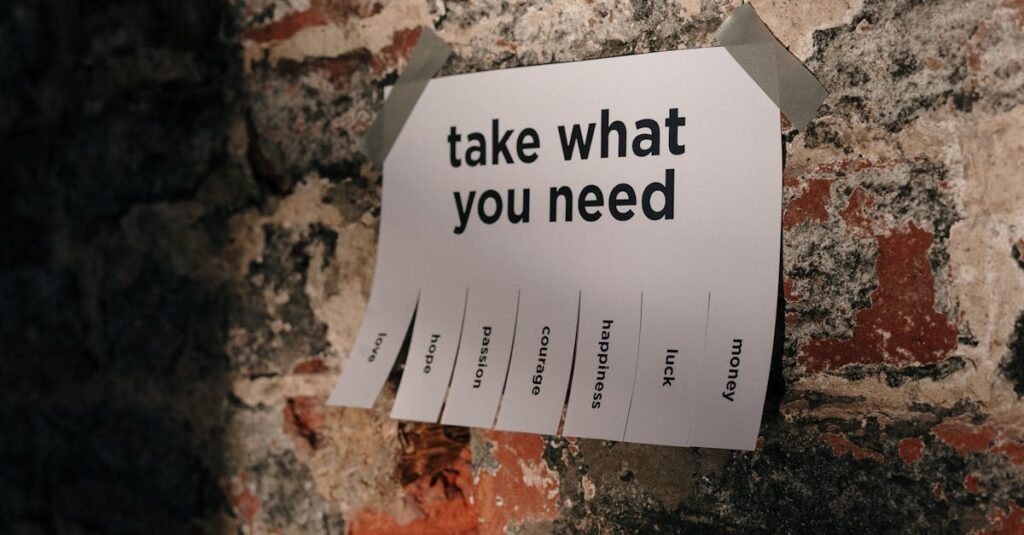 A motivational note offering positive qualities taped to a brick wall.